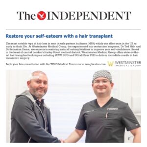 Two men posing for a photo, one with male pattern baldness and the other wearing a medical cap, both smiling, in a promotional image for a hair restoration medical group.